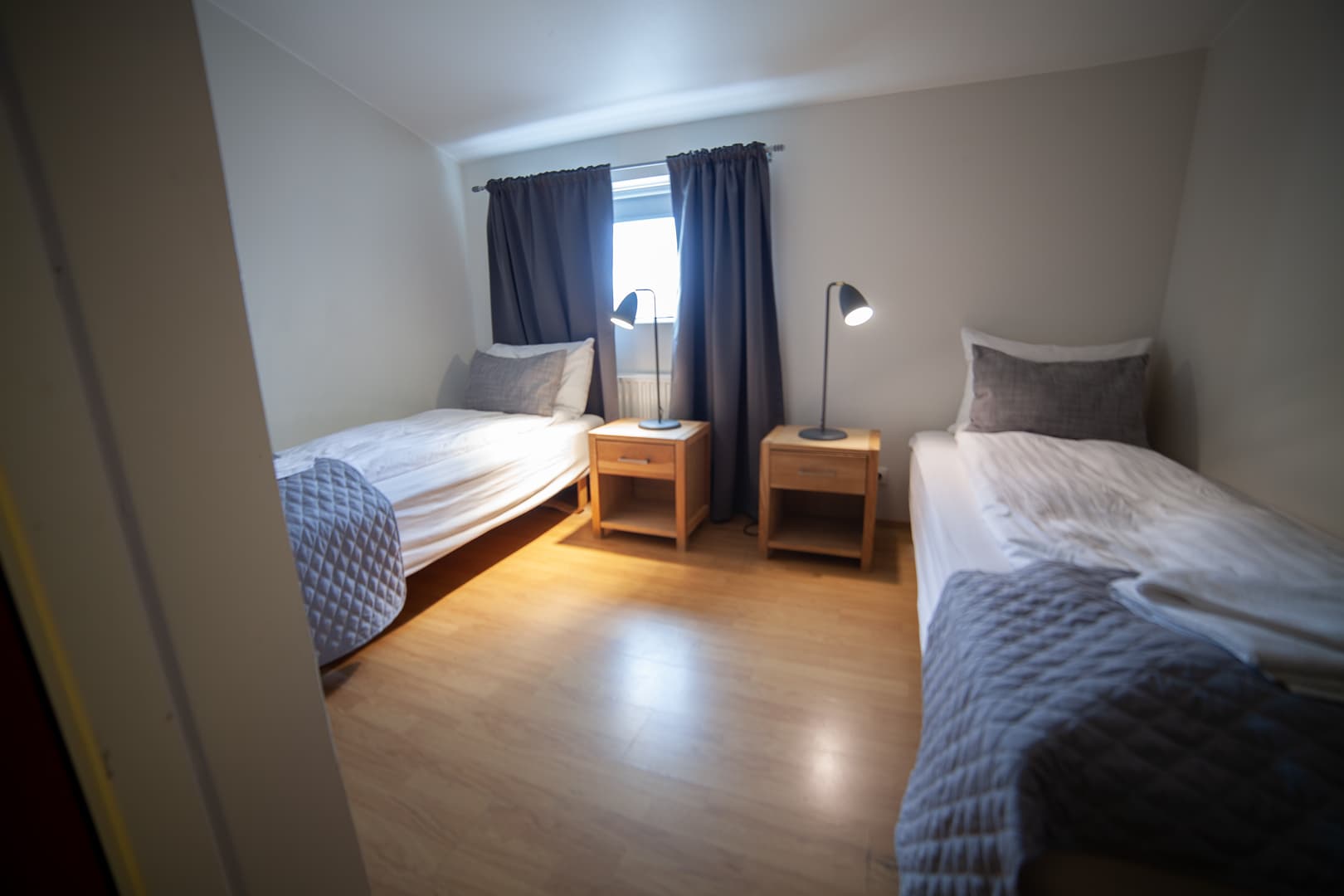 Twin room with two single beds and bedside lamps